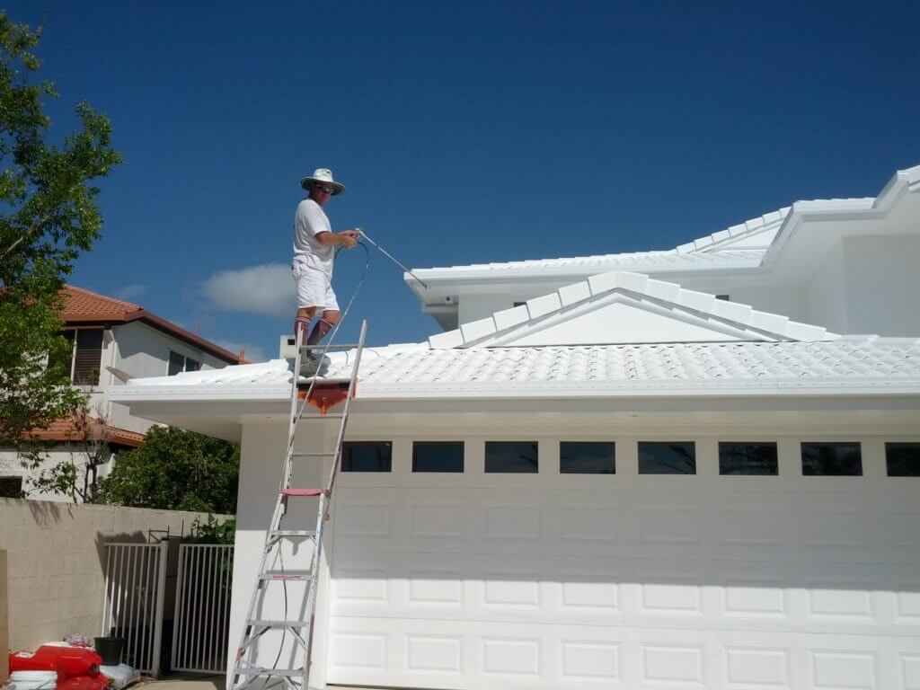 Scott's crew applying heat-reflective coating to a roof